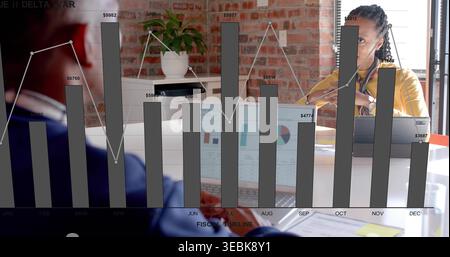 Reviewing woman in yellow top checking financial chart overlay on laptop at office, copy space Stock Photo