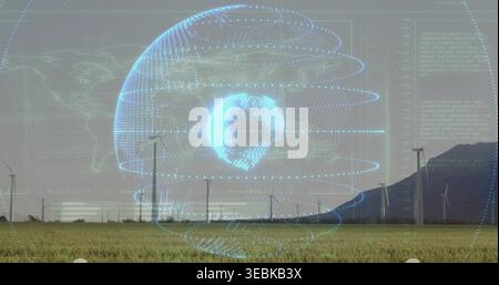 Displaying holographic digital globe overlaying rural wind farm plain, with turbines, poles, hill Stock Photo