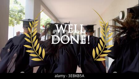 Walking graduates wearing black gowns and mortarboard caps down campus corridor, showing WELL DONE! Stock Photo