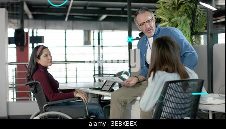 Discussing colleagues sharing plans at office windows, woman in wheelchair in burgundy top, paper Stock Photo