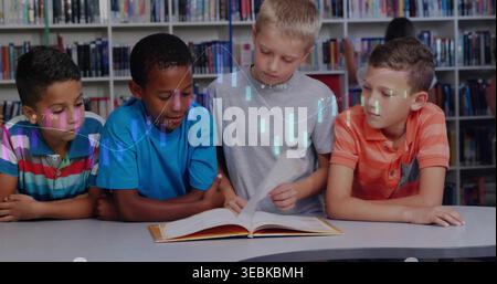 Reading four boys in bright shirts leaning over curved table at school library, with open book Stock Photo