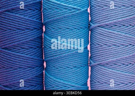 A close up studio shot of three spools of blue cotton cord in various shades. Stock Photo