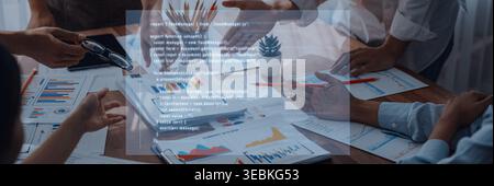 A dynamic business meeting showcases a diverse team collaborating over charts and documents, driving strategic planning and innovative solutions for Stock Photo
