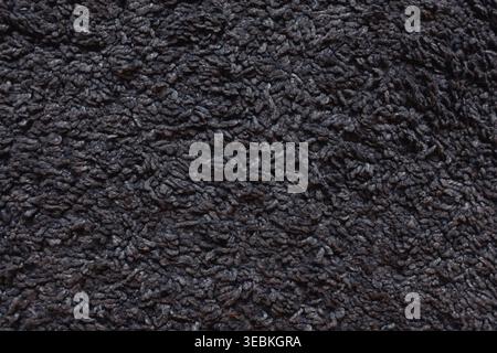 A Close-Up View of Cozy Dark Gray Knitted Fabric Showcasing Texture and Craftsmanship Stock Photo