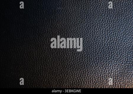 Black leather texture with a subtle, fine grain, perfect for backgrounds, upholstery, and fashion-related content and digital designs. Stock Photo