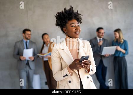 Group of multi-ethnic corporate business team collaborating on project in modern office Stock Photo