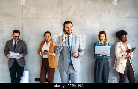 Multicultural professional businesspeople working together on research plan in boardroom. Stock Photo