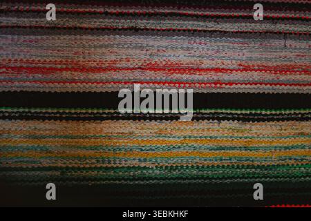 Colorful handmade rag rug texture, striped woven fabric background with blue and green threads Stock Photo