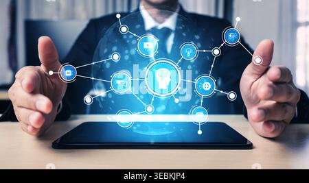 A businessman engages with a digital interface displaying various technology concepts. The futuristic imagery represents innovation and the power of Stock Photo