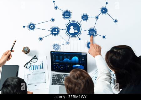 A modern workspace showcases a team analyzing data through technology and collaboration tools, promoting efficiency and innovative strategies for Stock Photo