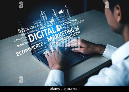 A person types on a laptop in a modern setting, surrounded by virtual elements of digital marketing, highlighting strategies for online growth and Stock Photo