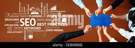 A dynamic view of teamwork focused on SEO strategy and data analytics. Hands arranged on a table displaying a puzzle piece concept representing Stock Photo