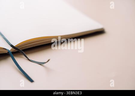 Open dot grid notebook with ribbon bookmark in soft light Stock Photo