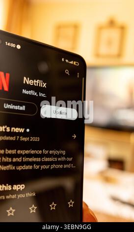 Madrid, Spain 07-09-2023: Person holding a smartphone to update the Netflix app in September 2023 Stock Photo