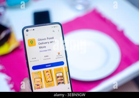 Madrid, Spain 07-09-2023: A person holds a mobile phone displaying information about the Glovo app, a popular delivery service in Europe. Stock Photo