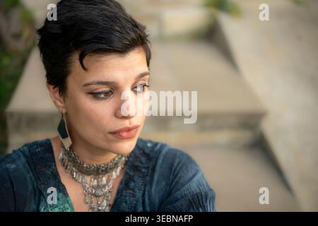 Close up portrait of a woman looking down with worried expression Stock Photo