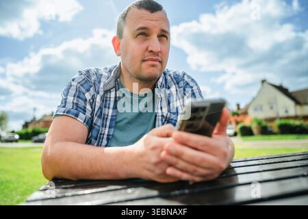 Man using smartphone, outdoors portrait Stock Photo