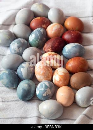 Dyed Easter Eggs with Floral Imprints on White Linen Stock Photo