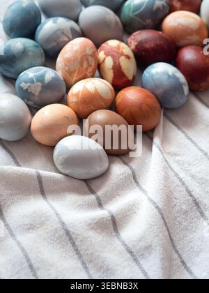 Dyed Easter Eggs with Floral Imprints on White Linen Stock Photo