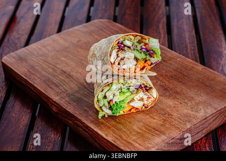 Stacked chicken wraps filled with fresh vegetables and grilled chicken Stock Photo