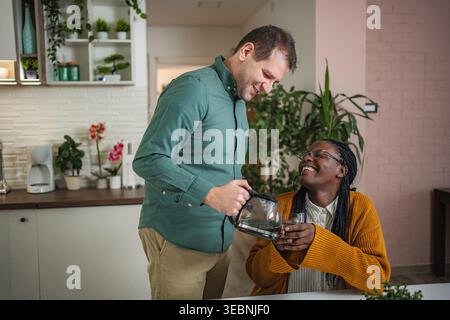 Happy interracial couple enjoying morning coffee together Stock Photo