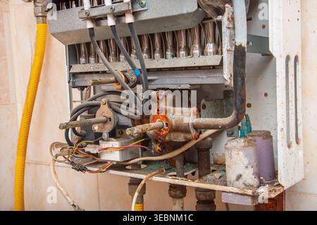 Old and rusty water heater interior showing signs of disrepair and wear Stock Photo