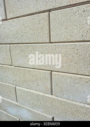 close up view of a textured concrete block wall with subtle speckles Stock Photo