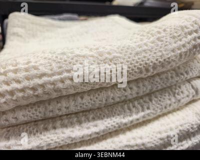 close up view of a stack of soft, white, textured knitted fabric layers Stock Photo