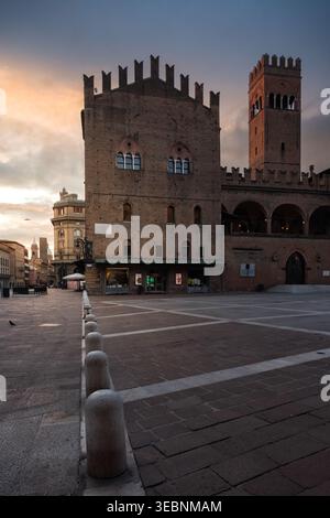 Bologna, Italy - 27 March 2022: View of Palazzo Re Enzo's weathered brick facade against the soft hues of the sunset sky, creating a scene of timeless Stock Photo