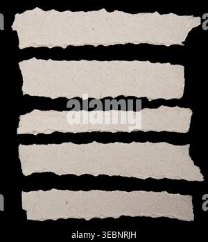 Ripped paper strips on black background Stock Photo