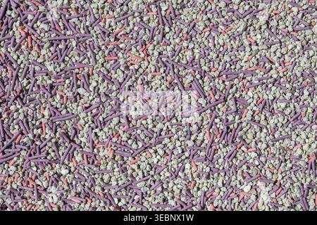 Close-up of colorful granular texture with purple, pink, and white particles Stock Photo