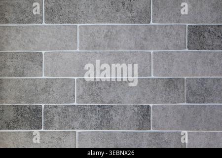 Close-up of gray brick wall with white mortar joints Stock Photo