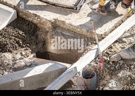 Builder using a hammer while preparing the foundation of a new building Stock Photo