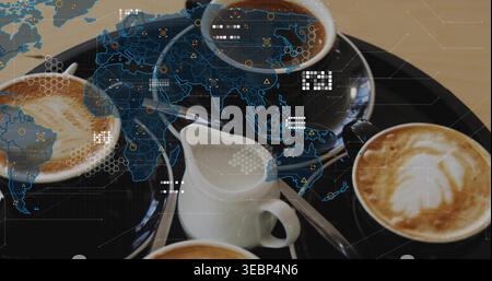 Displaying black round tray holding four cups on wood table, creamer, two-teaspoons, blue HUD map Stock Photo