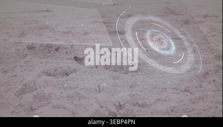 Projecting holographic HUD over sandy surface at low-angle close-range, showing circular radar Stock Photo