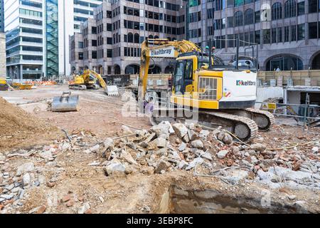 Construction site with yellow excavator in the city. London, UK, 29 March 2024 Stock Photo