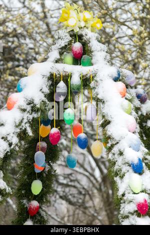 Traditional Saxon Easter Well crown with colorful eggs in Snow in a Garden Stock Photo
