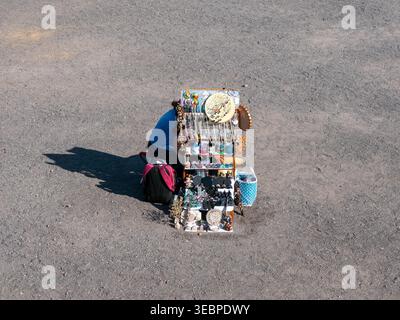 High angle view of a Mexican street vendor displaying handmade artisanal jewelry and colorful souvenirs on a small stand in Teotihuacan Mexico Stock Photo