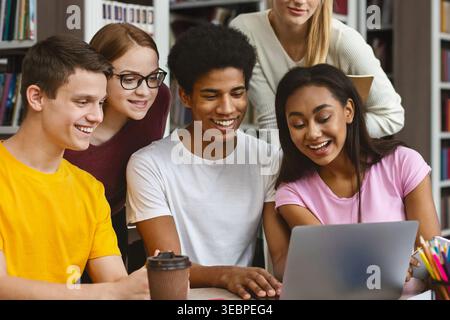 Group of Students Collaborating on a Project in a Library During the Afternoon Stock Photo