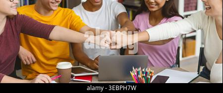 Group of Friends Collaborating on a Project With Enthusiasm and Creativity in a Cozy Workspace Stock Photo