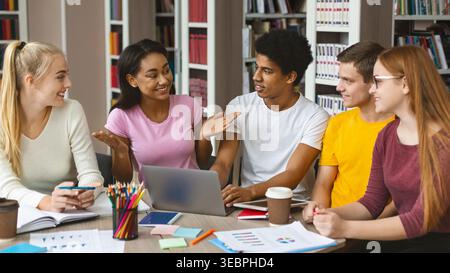 Students Engaged in Group Discussion at a Library During Study Session in Afternoon Hours Stock Photo