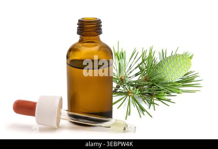 Deodar cedar (Cedrus deodara) essential oil in a glass dropper bottle, isolated on white background. Natural aromatherapy product, herbal extract conc Stock Photo