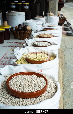 Outdoor market display with rows of white sacks filled with dried beans, legumes Stock Photo
