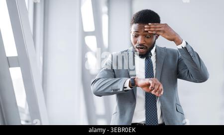 Businessman Missed Plane, Looking At Watch At Airport Stock Photo