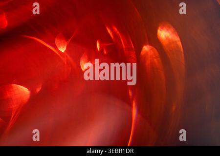 Abstract image featuring swirling red and orange light patterns against a dark backdrop, highlighting vibrant colors and dynamic shapes in a captivati Stock Photo