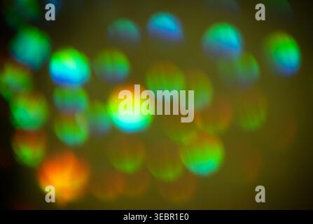 Abstract background featuring blurred circular shapes in vibrant colors, including blue, green, yellow, and red, creating a colorful bokeh effect Stock Photo