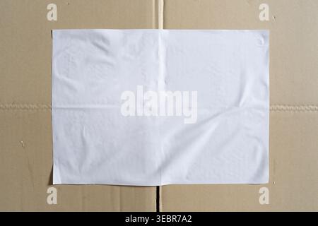 Blank White Paper Mockup Glued on Brown Corrugated Cardboard Stock Photo