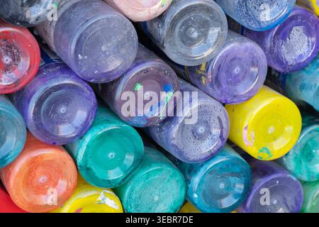 Colorful paint jars stacked in a close-up composition. The image conveys creativity, craft, studio atmosphere and playful color harmony Stock Photo