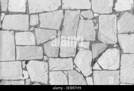 A high-resolution image of a seamless textured stone wall, featuring a rustic pattern in gray tones. Ideal as a background or texture for design and a Stock Photo