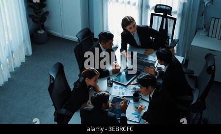 Top view businesspeople placed tablet at table and planning strategy while diverse team discuss about financial plan. Group of diverse team brainstorm Stock Photo